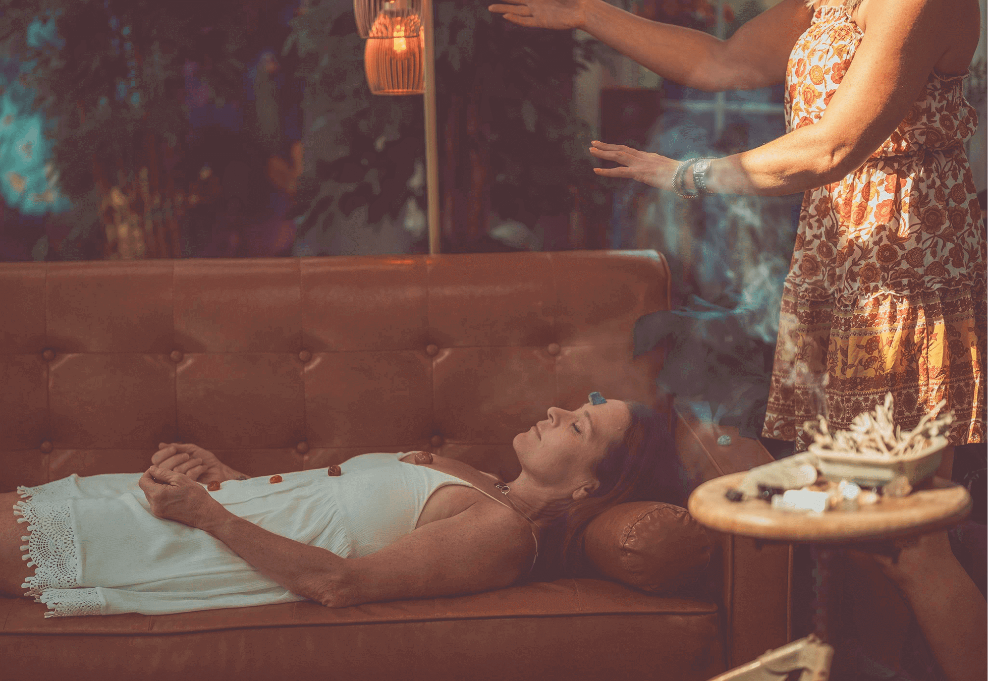 Reiki session with a woman lying down.