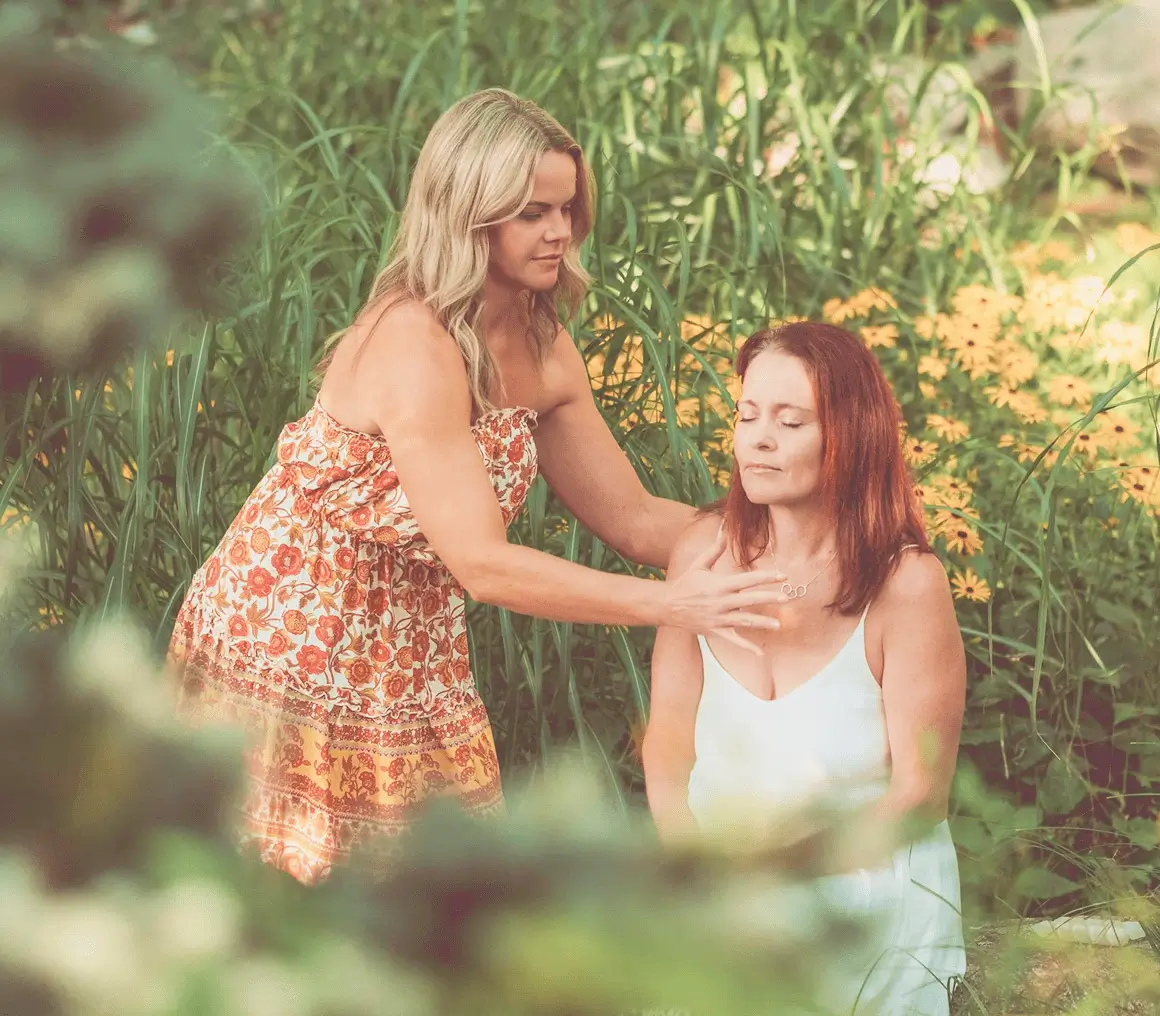 Two women in a calming outdoor setting.
